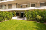 Experience modern living in this stunning property featuring a spacious balcony with glass railings and sleek blinds.