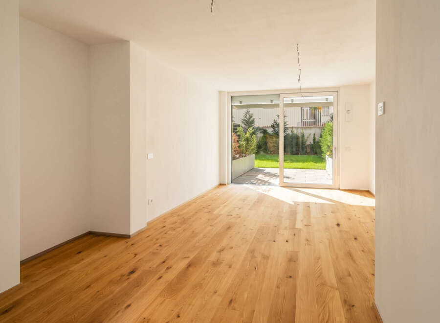 Experience modern living in this bright and airy room featuring a stunning natural wood floor that extends throughout the space.