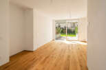 Experience modern living in this bright and airy room featuring a stunning natural wood floor that extends throughout the space.