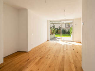 Experience modern living in this bright and airy room featuring a stunning natural wood floor that extends throughout the space.