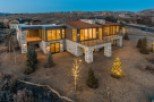 Stunning modern mountain home with expansive windows offering breathtaking views.