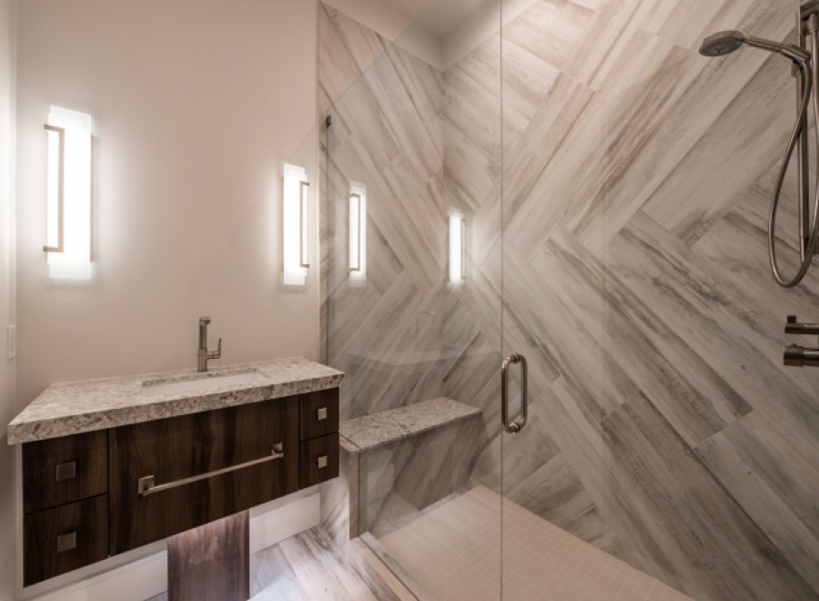 This luxurious bathroom boasts a spacious walk-in shower with a built-in bench and sleek, modern fixtures.