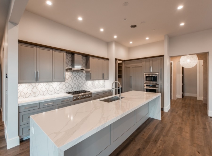 This stunning kitchen boasts a large island with a marble countertop, perfect for entertaining.