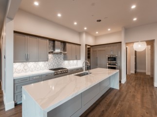 This stunning kitchen boasts a large island with a marble countertop, perfect for entertaining.