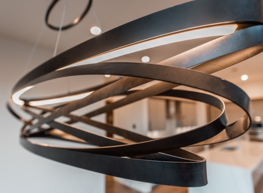 Modern pendant light fixture with sleek, dark metal design.