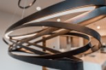 Modern pendant light fixture with sleek, dark metal design.