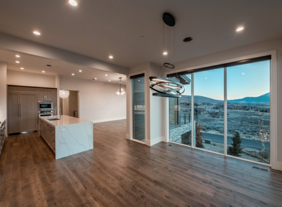 This stunning home boasts an open-concept kitchen and dining area with breathtaking views.