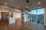 This stunning home boasts an open-concept kitchen and dining area with breathtaking views.