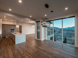 This stunning home boasts an open-concept kitchen and dining area with breathtaking views.