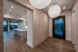 Stunning entryway with modern lighting and hardwood floors.