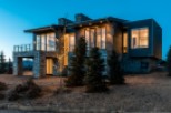 Stunning mountain modern home with expansive windows offering breathtaking views.