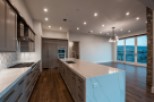 This stunning kitchen boasts modern gray cabinetry, sleek countertops, and high-end appliances.