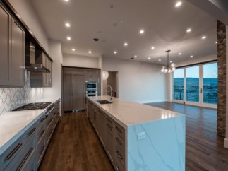 This stunning kitchen boasts modern gray cabinetry, sleek countertops, and high-end appliances.