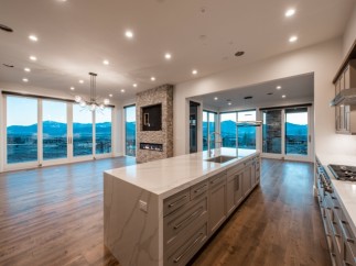 This stunning home boasts an open floor plan with breathtaking mountain views from expansive windows.