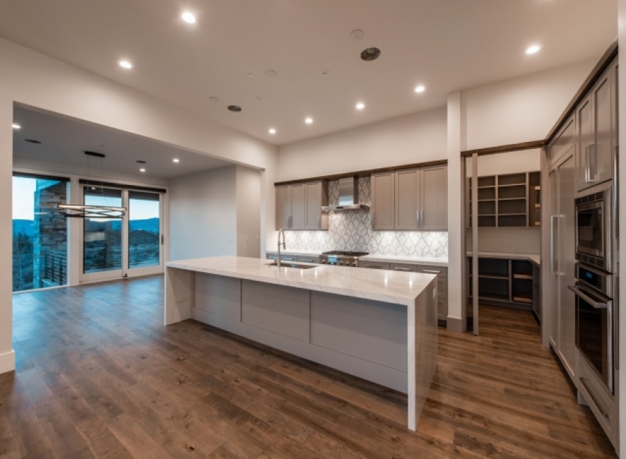 Stunning kitchen with expansive windows offering breathtaking views, complemented by modern cabinetry and high-end appliances.