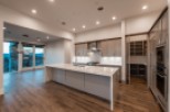 Stunning kitchen with expansive windows offering breathtaking views, complemented by modern cabinetry and high-end appliances.