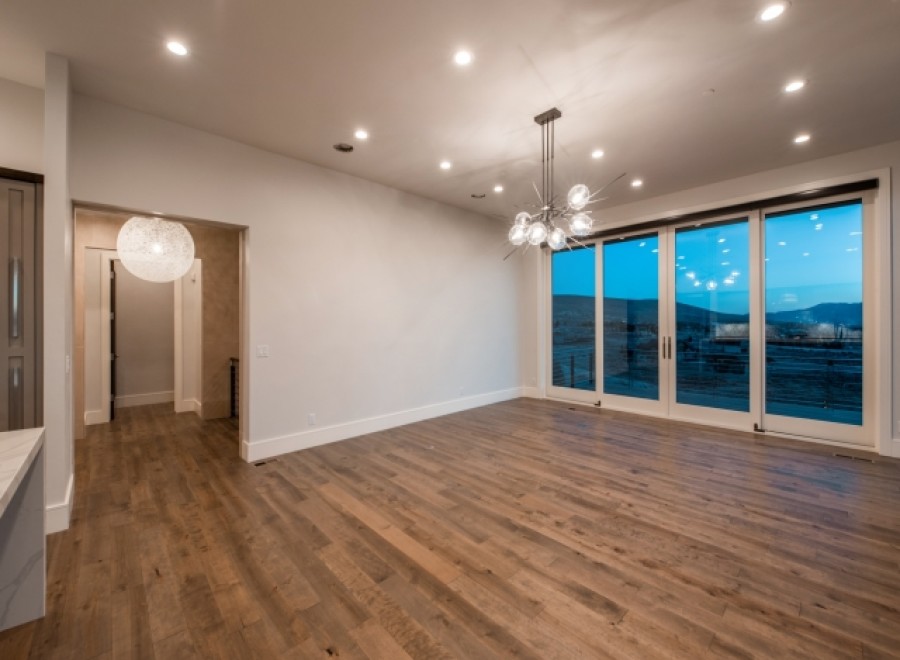 This stunning home boasts an open floor plan with hardwood floors and large windows offering breathtaking views.