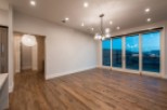 This stunning home boasts an open floor plan with hardwood floors and large windows offering breathtaking views.