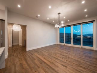 This stunning home boasts an open floor plan with hardwood floors and large windows offering breathtaking views.