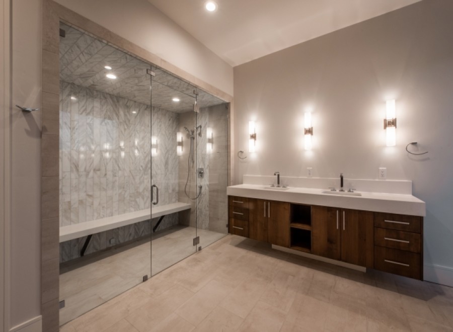 This luxurious bathroom boasts a spacious walk-in shower with a built-in bench and sleek glass enclosure.