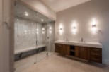 This luxurious bathroom boasts a spacious walk-in shower with a built-in bench and sleek glass enclosure.