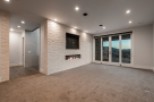 This stunning property boasts a spacious, open-plan basement perfect for entertaining, featuring a modern fireplace and wall-mounted TV.