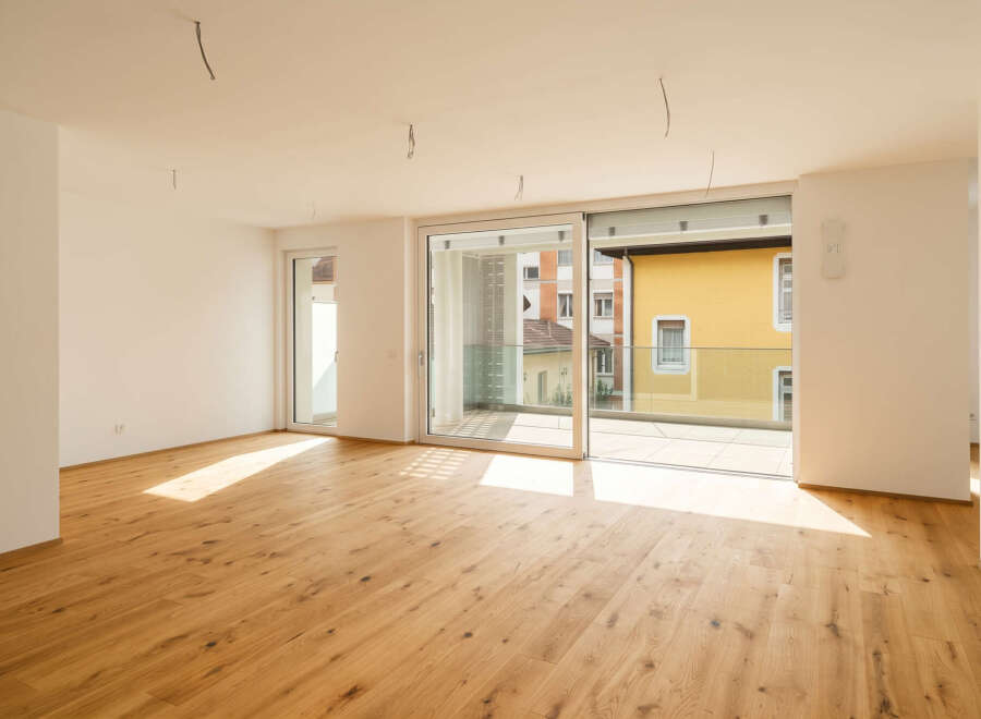 Experience modern living in this bright and airy apartment featuring a spacious open-plan living area with beautiful hardwood floors.