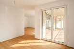 Step into this bright and airy modern apartment, featuring gleaming hardwood floors that catch the sunlight streaming through expansive glass doors.