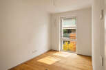 Experience modern living in this unfurnished room featuring a large window that floods the space with natural light.