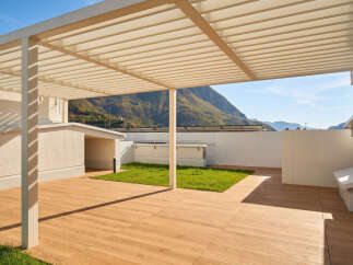Experience modern living with this stunning rooftop terrace, featuring a sleek pergola offering shade and style.