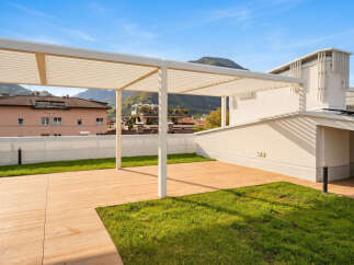 Experience modern outdoor living with this spacious rooftop terrace, featuring a sleek white pergola providing ample shade.