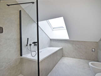 This modern bathroom features a sleek design with a skylight, offering ample natural light.