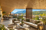 Experience luxurious outdoor living on this expansive balcony, featuring a comfortable seating area and a dining set perfect for al fresco meals.