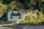 Nestled amidst lush greenery, this charming property offers a serene escape.