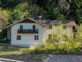 Nestled amidst lush greenery, this charming property offers a serene escape.