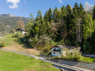 Nestled in a picturesque mountain setting, this charming property offers a tranquil escape.