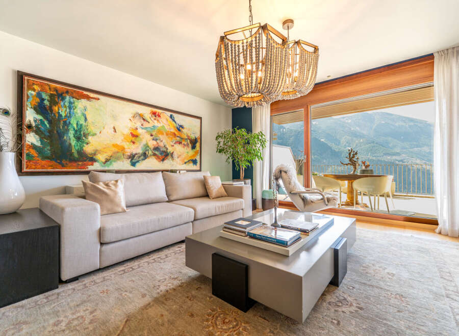 Experience luxury living in this stunning property, featuring a spacious living room with breathtaking mountain views.