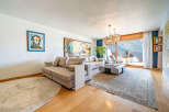 Experience luxury living in this stunning property, featuring a spacious living room with a modern sofa and elegant decor.