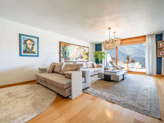 Experience luxury living in this stunning property, featuring a spacious living room with a modern sofa and elegant decor.