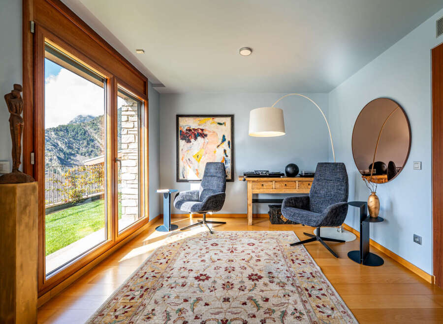 Experience luxury living in this stunning property, featuring a bright and airy living room with breathtaking mountain views.