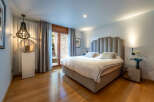 Step into luxury with this stunning bedroom, featuring a plush, upholstered headboard and a serene ambiance.