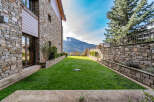 Discover the charm of this stunning property, featuring a beautifully manicured lawn and a backdrop of majestic mountains.