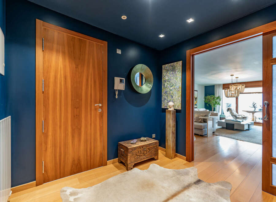 Step into luxury with this stunning entryway, showcasing a rich wooden door and elegant design.