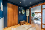Step into luxury with this stunning entryway, showcasing a rich wooden door and elegant design.