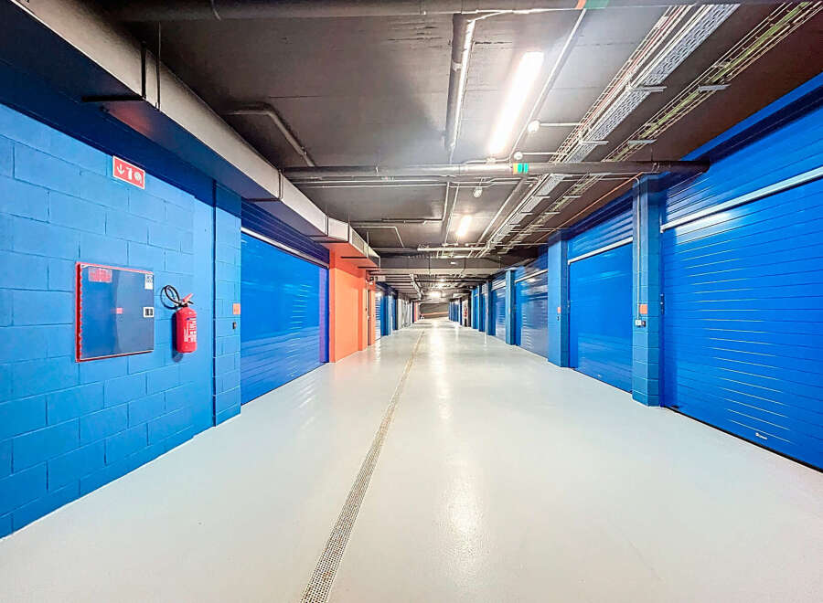 Explore this secure storage facility featuring individual units with vibrant blue doors.