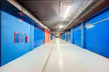 Explore this secure storage facility featuring individual units with vibrant blue doors.