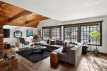 This stunning living room boasts a cozy atmosphere with its inviting sectional sofa and a plush, dark-colored rug.
