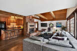 This stunning property boasts a cozy living space with a brick fireplace and a modern kitchen.
