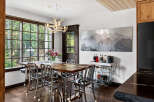 This stunning dining room boasts a rustic wooden table, perfect for hosting gatherings.