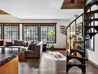 Step into luxury with this stunning property featuring a spiral staircase and a beautifully designed living space.
